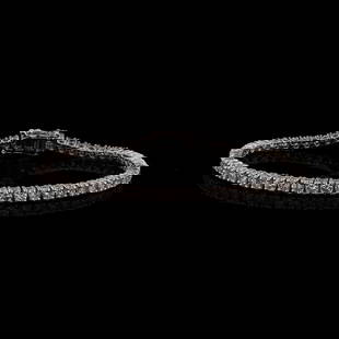 5.62ctw Diamond 14K White Gold Tennis Bracelet: One electronically tested 14KT white gold ladies cast and assembled graduated diamond tennis bracelet. The seven inch length bracelet is composed of a flexible graduating ribbon of diamonds, terminati