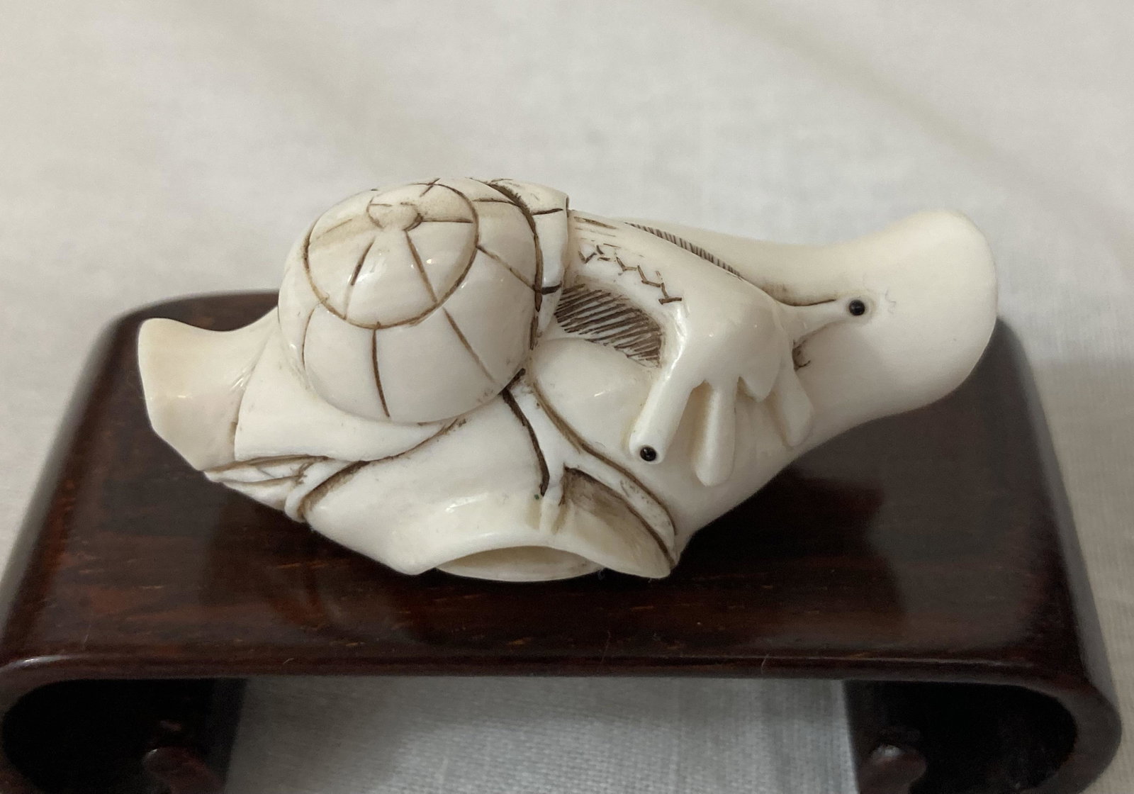 SNAIL ON LOTUS LEAF Netsuke Early-20th Century Signed KASEKI: ARTIST: Kaseki TITLE: Snail on Lotus Leaf MEDIUM: Hand-carved Netsuke SIZE: 2" x 1" DESCRIPTION: Up for auction is a beautiful hand-carved netsuke depicting a snail on a lotus leaf and signed Kaseki.<