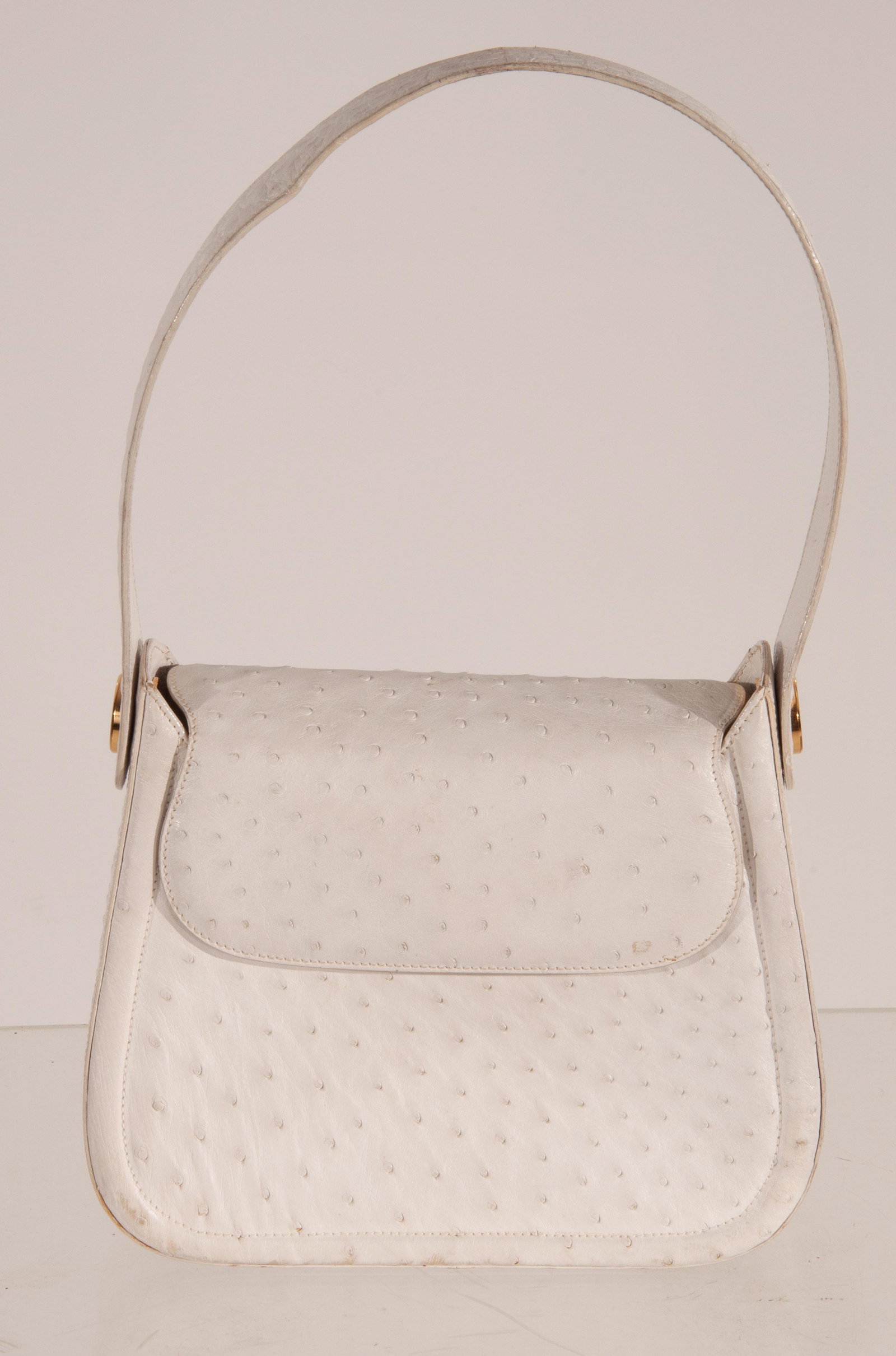 Suarez Ostrich Leather Shoulder Bag: Suarez Ostrich White Leather Shoulder Bag, Gold Button Details on Sides; Signs of Wear; Top of Stap To Base of Bag:18; BAG Base: 8x10x3