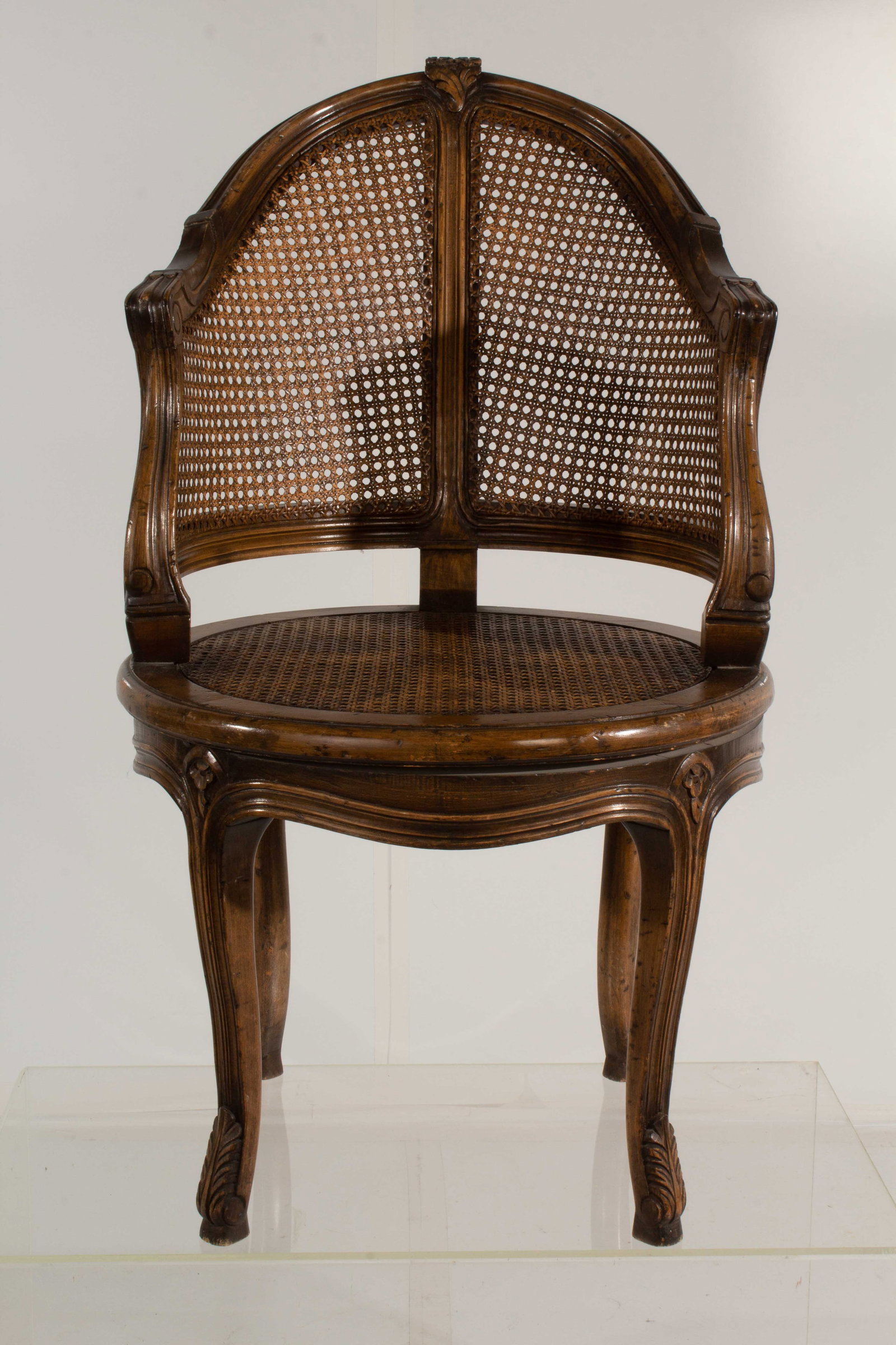 Vintage Cane Swivel Armchair: Minor cosmetic damage to finish; weathered and worn from age