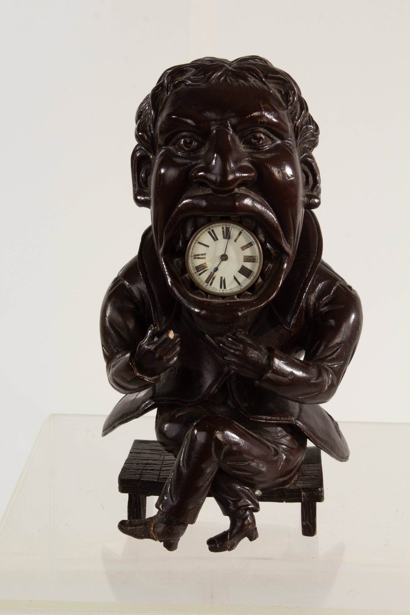 Grotesque Man Clock: Broken finger; repaired feet and bench.