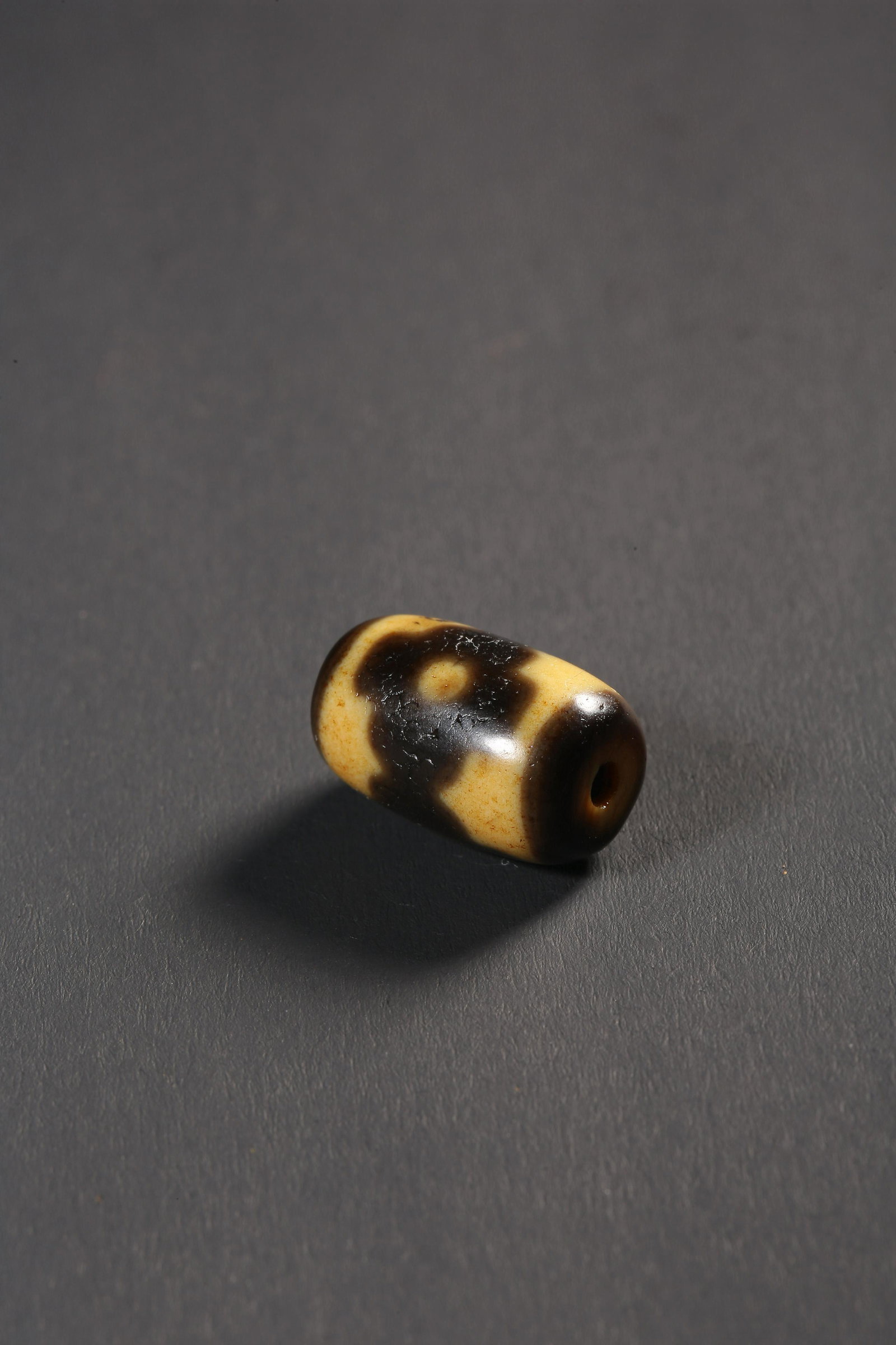 A THREE-EYED DZI BEAD (1 of 4)