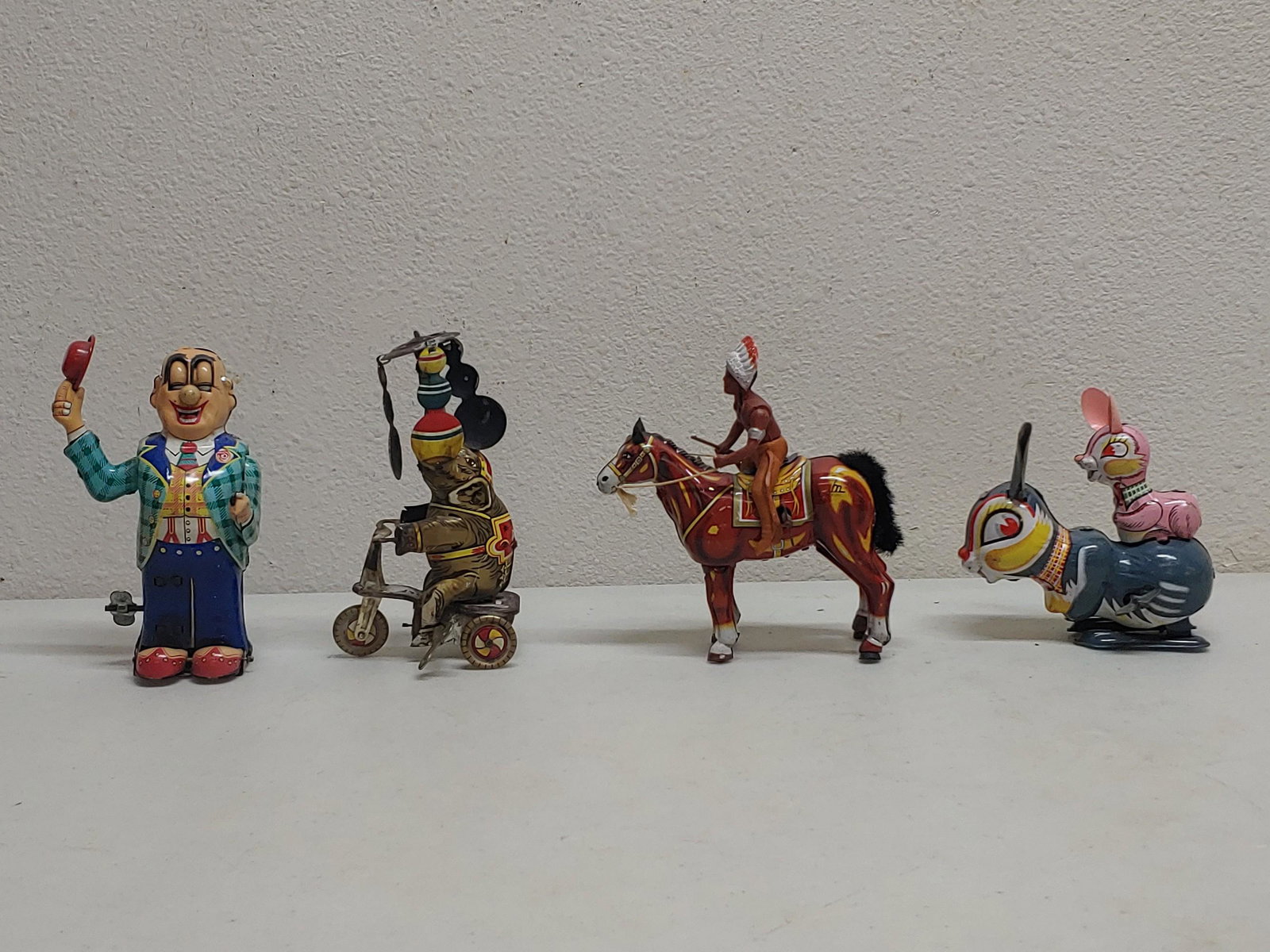 Wind up tin toys: Tallest approx 6 in works Funny missing ear needs small adjustments