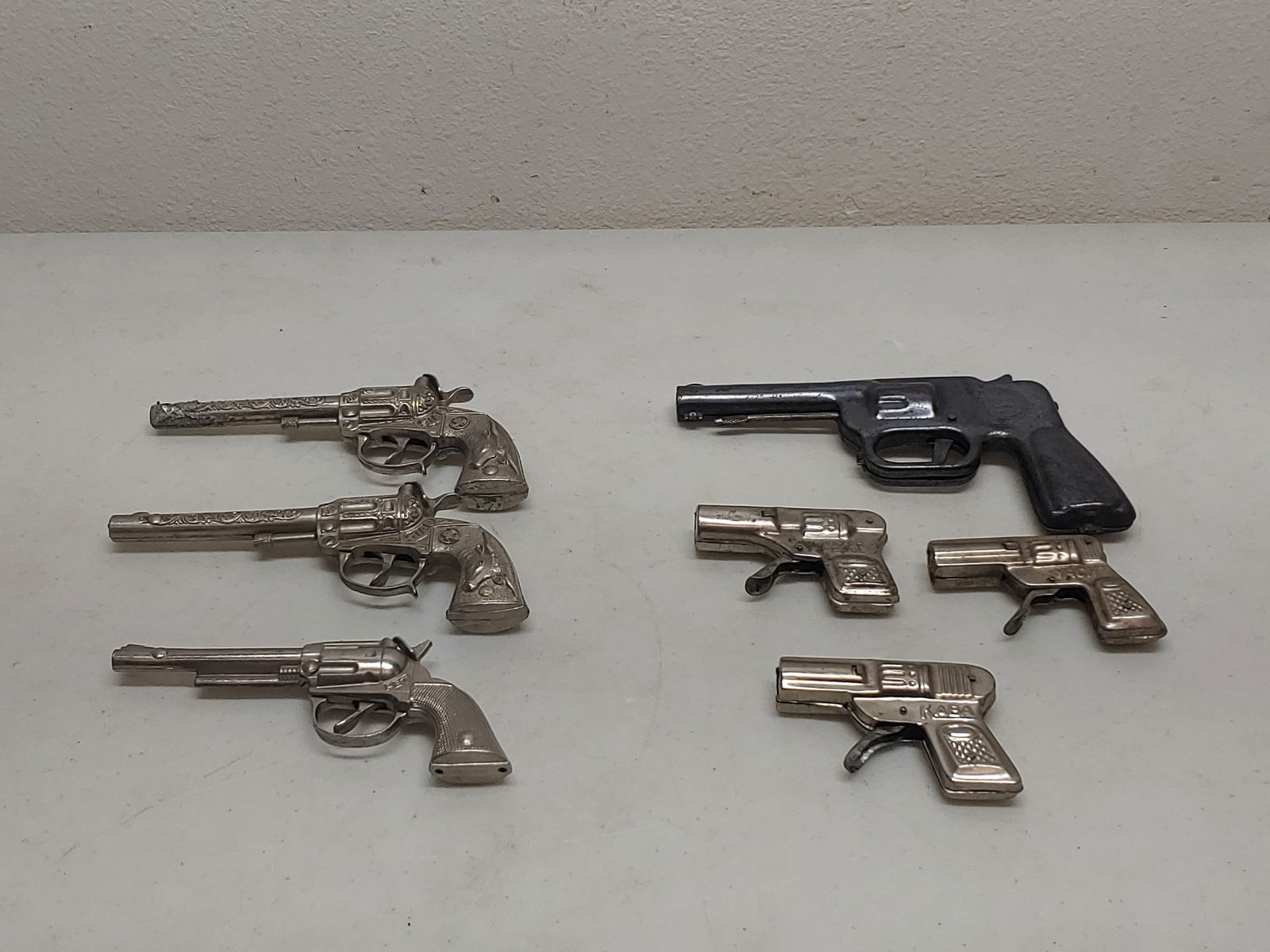 3 Cap Guns 4 Water Pistols One Daisy: Longest approx 7.5 in