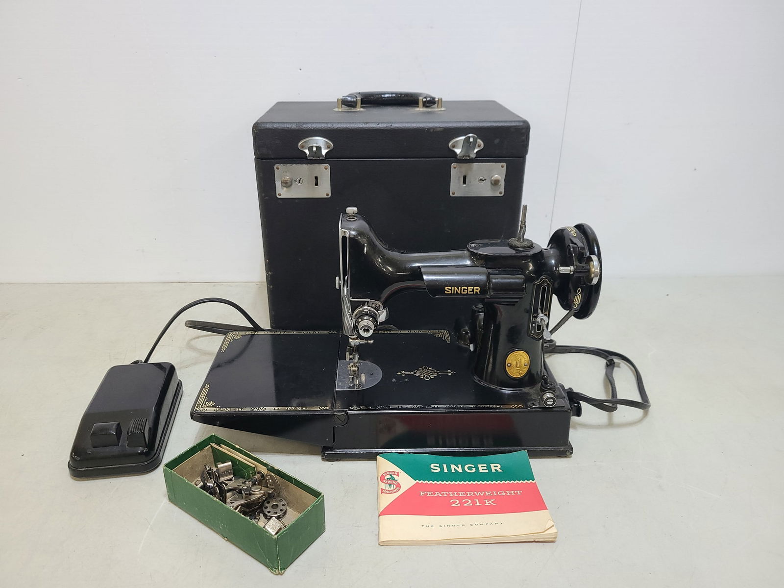 Singer Featherweight Sewing Machine: Working Serial number AJ190877 Appears to be in very nice condition with original carrying case.