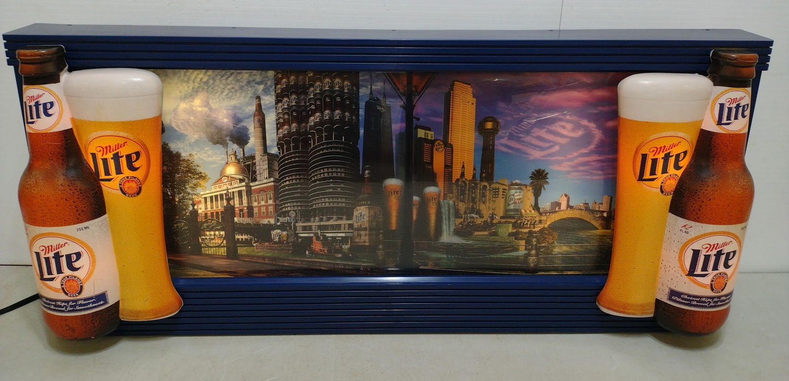 Miller Lite Lighted Rotating Advertising Sign: Awesome scenery at rolls from right to left approximately 6 in per minute. NICE!! Sign measures approximately 39x17.5 in and 6 in deep.