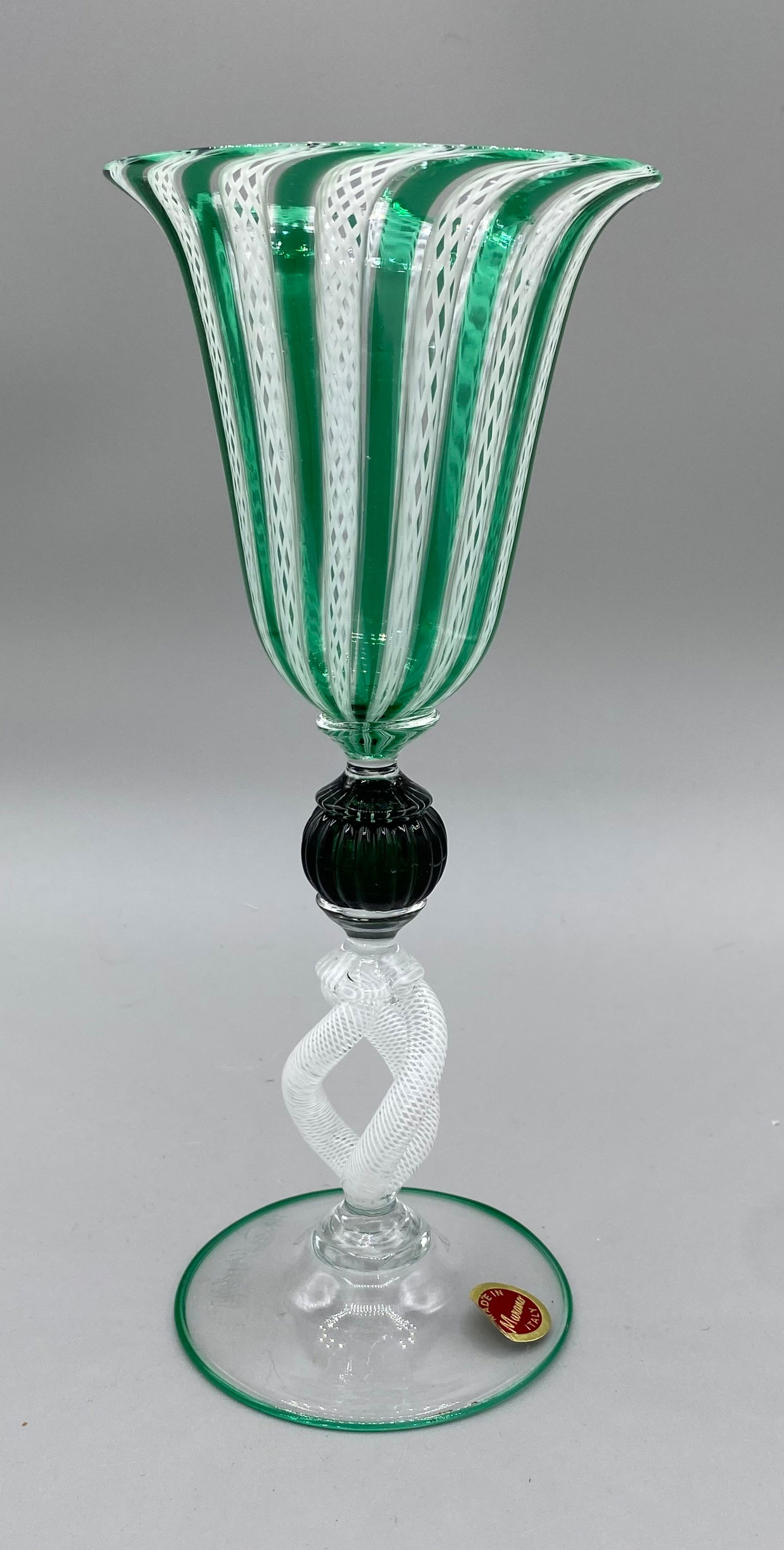 Murano Latticino Signed Unusual Stem Goblet Has Label: This is a green and latticino stem with a black detail on the stem. The stem is very unusual as it has 3 latticino pieces. It has a signature and a label that states Made In Italy. It stands approx. 8