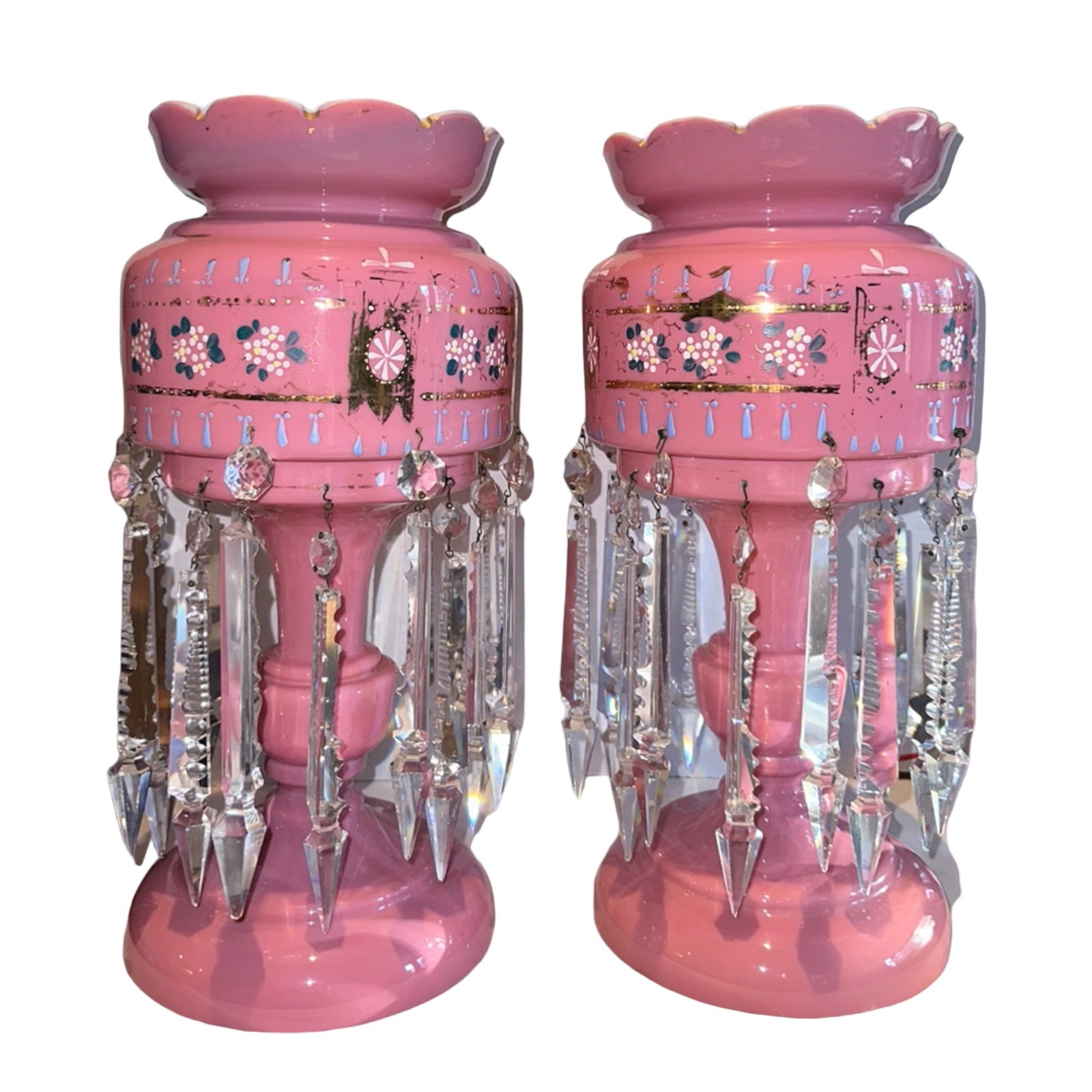 Pair Mantle Lusters Pink Cased Glass Prisms: This is a matching pair of pink cased glass mantle lusters. They have white interiors. There is enamel florals with gold. There is wear to the gold. There is a double row of prisims. These stand 14 3/