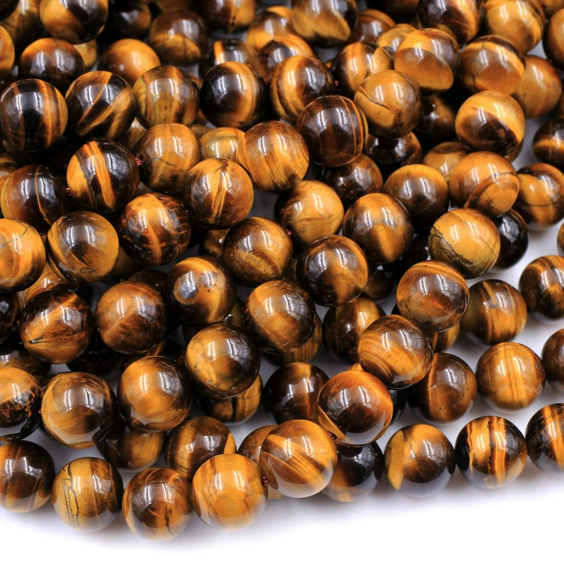 Natural Tiger's Eye Gemstone 6 mm Round Smooth Beads 5 Strand: Natural Tiger's Eye Gemstone 6 mm Round Smooth Beads 5 Strand 15.5 Inches Each Product Type : Loose Beads Strand Gemstone : Tiger's Eye Beads Shape : Round Smooth Plain Beads Size : 6 mm Quant