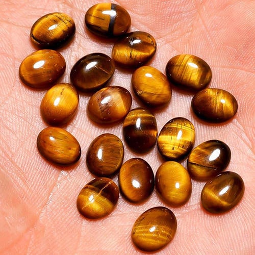 Tiger's Eye 7x5 MM Oval Cabochon 25 Pieces: Natural Tiger's Eye 7x5 MM Oval Cabochon 25 Pieces Gemstone : Tiger's Eye Shape : Oval Size : 7x5 MM Color : Brown Type : Cabochon Quantity : 25 Pieces Weight : 25 Cara