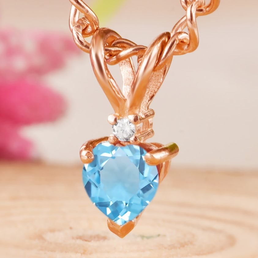 Natural Blue Topaz & Diamond 14 KT Rose Gold Pendant: Natural Blue Topaz & Diamond 14 KT Rose Gold Pendant Jewelry Type : Pendant Main Stone : Blue Topaz & Diamond Main Stone Shape & Size : Heart 5x5 MM Main Stone Color : Blue Diamond Shape & Size : R