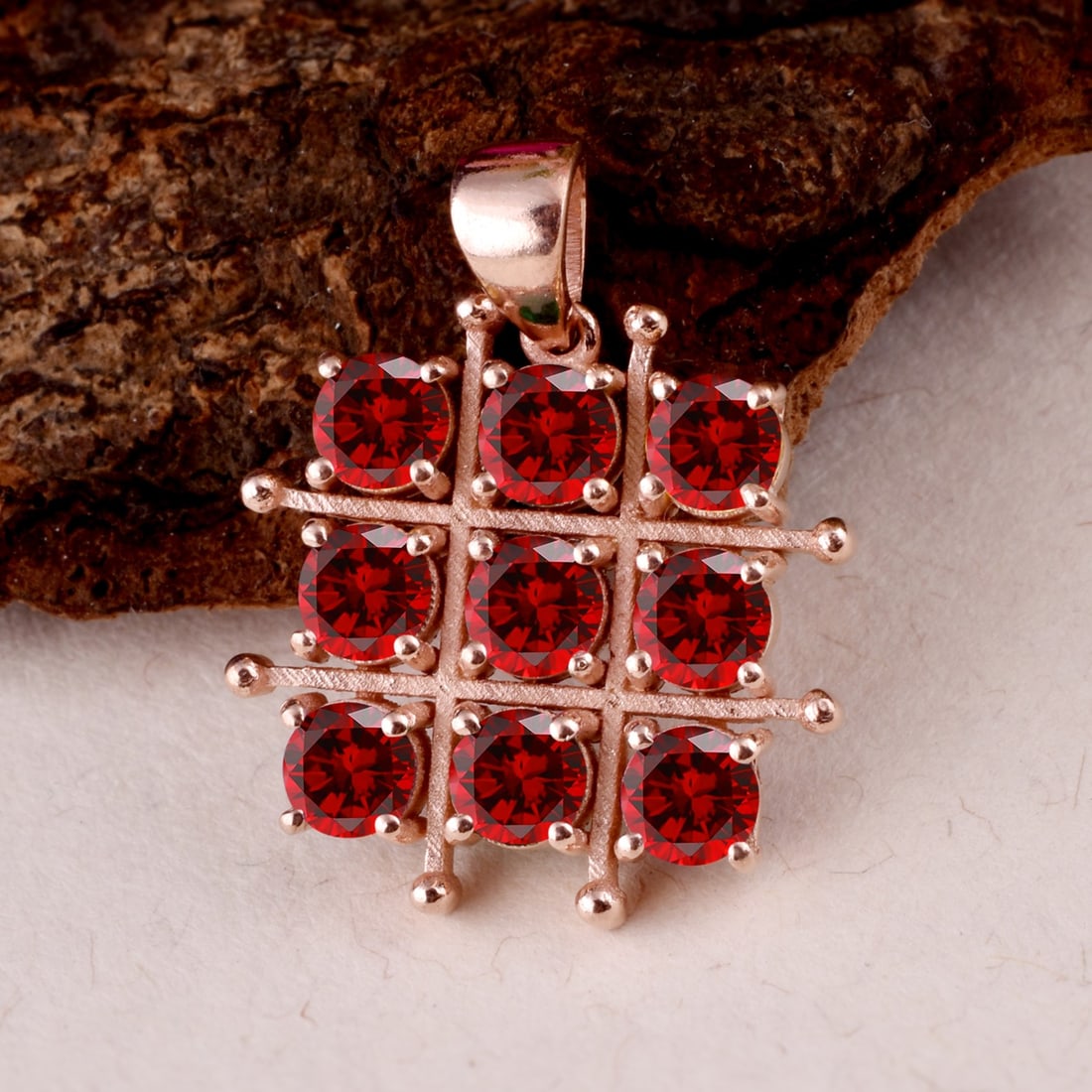 Natural Garnet 14 KT Rose Gold Pendant: Natural Garnet 14 KT Rose Gold Pendant Jewelry Type : Pendant Main Stone : Garnet Main Stone Shape & Size : Round 4 MM (9 Pieces) Main Stone Color : Red