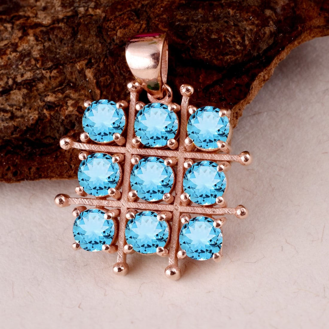 Natural Blue Topaz 14 KT Rose Gold Pendant: Natural Blue Topaz 14 KT Rose Gold Pendant Jewelry Type : Pendant Main Stone : Blue Topaz Main Stone Shape & Size : Round 4 MM (9 Pieces) Main Stone Color : Blue