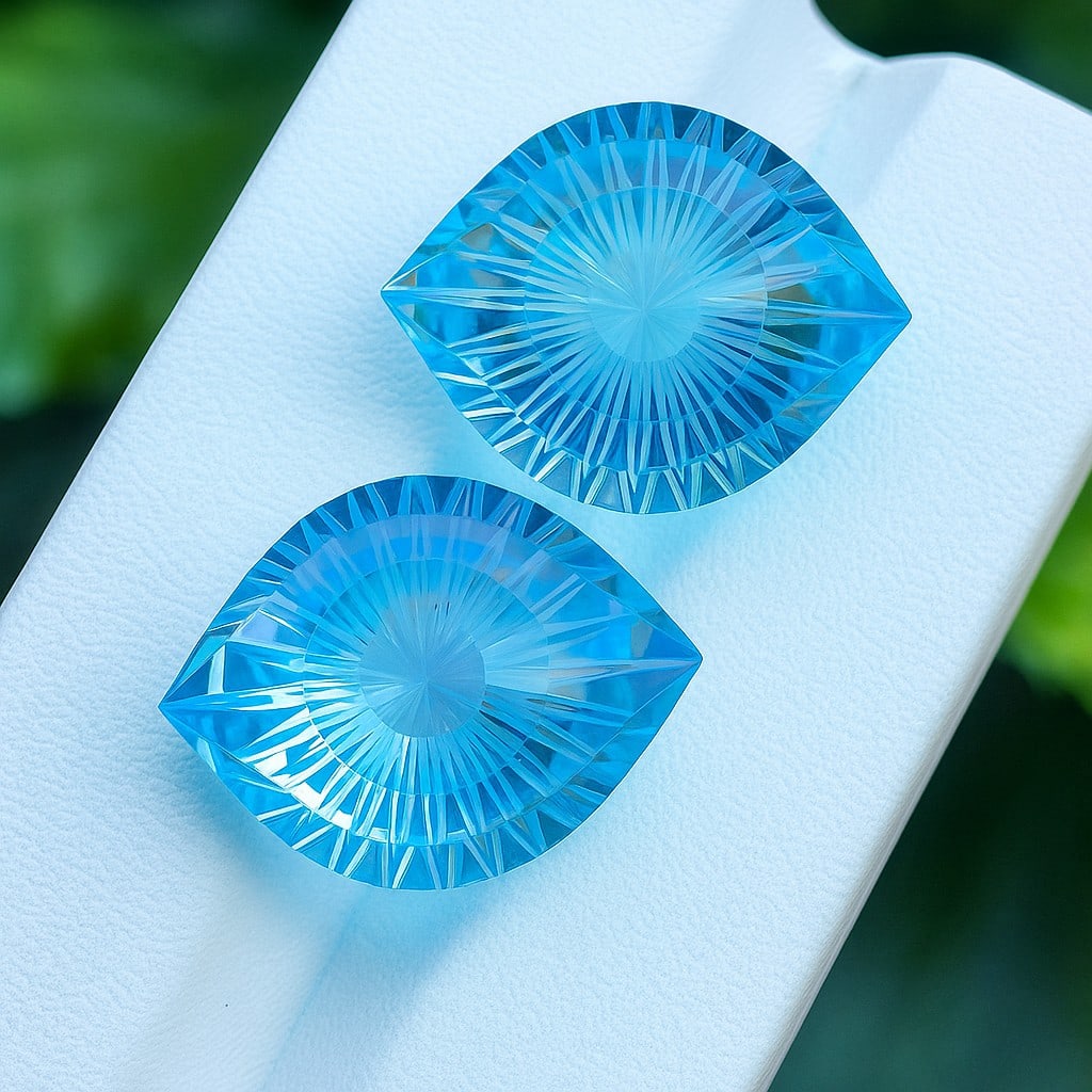 Natural Blue Topaz Eye Carved Hand Cut 35.6 Cts. Pair: Natural Blue Topaz Eye Carved Hand Cut 35.6 Cts. Pair Blue Topaz Shape : Eye Carved Size : 18x13x11 MM Color : Blue Type : Hand Cut Quantity : 2 Piece Weight : 35.6 Carats