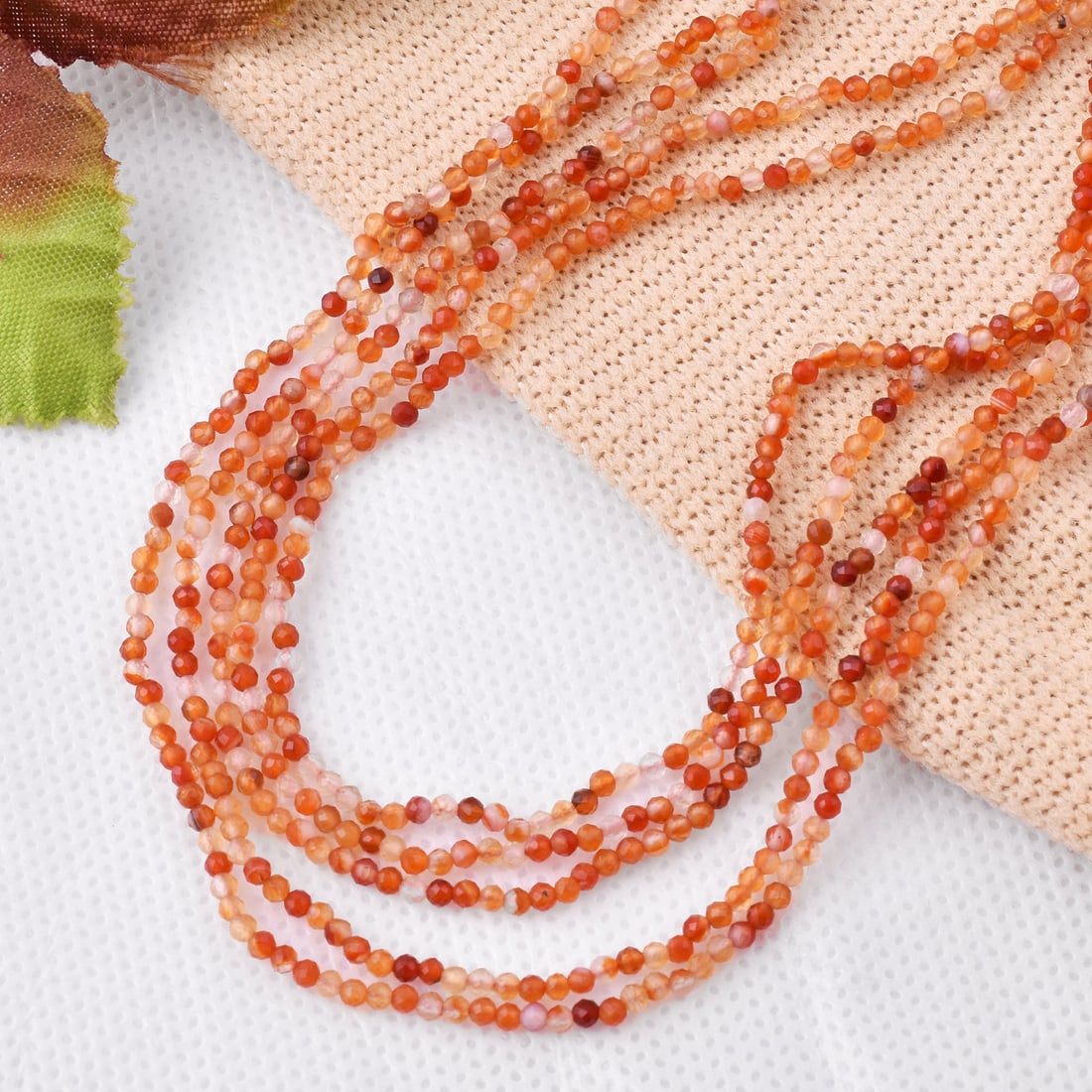 Natural Carnelian 2 MM Round Faceted 5 String Beads Necklace: Natural Carnelian 2 MM Round Faceted 5 String Beads Necklace Product Type : Necklace Main Stone : Carnelian Main Stone Shape : Round Main Stone Size : 2 MM Beads Type : Faceted Closure Type