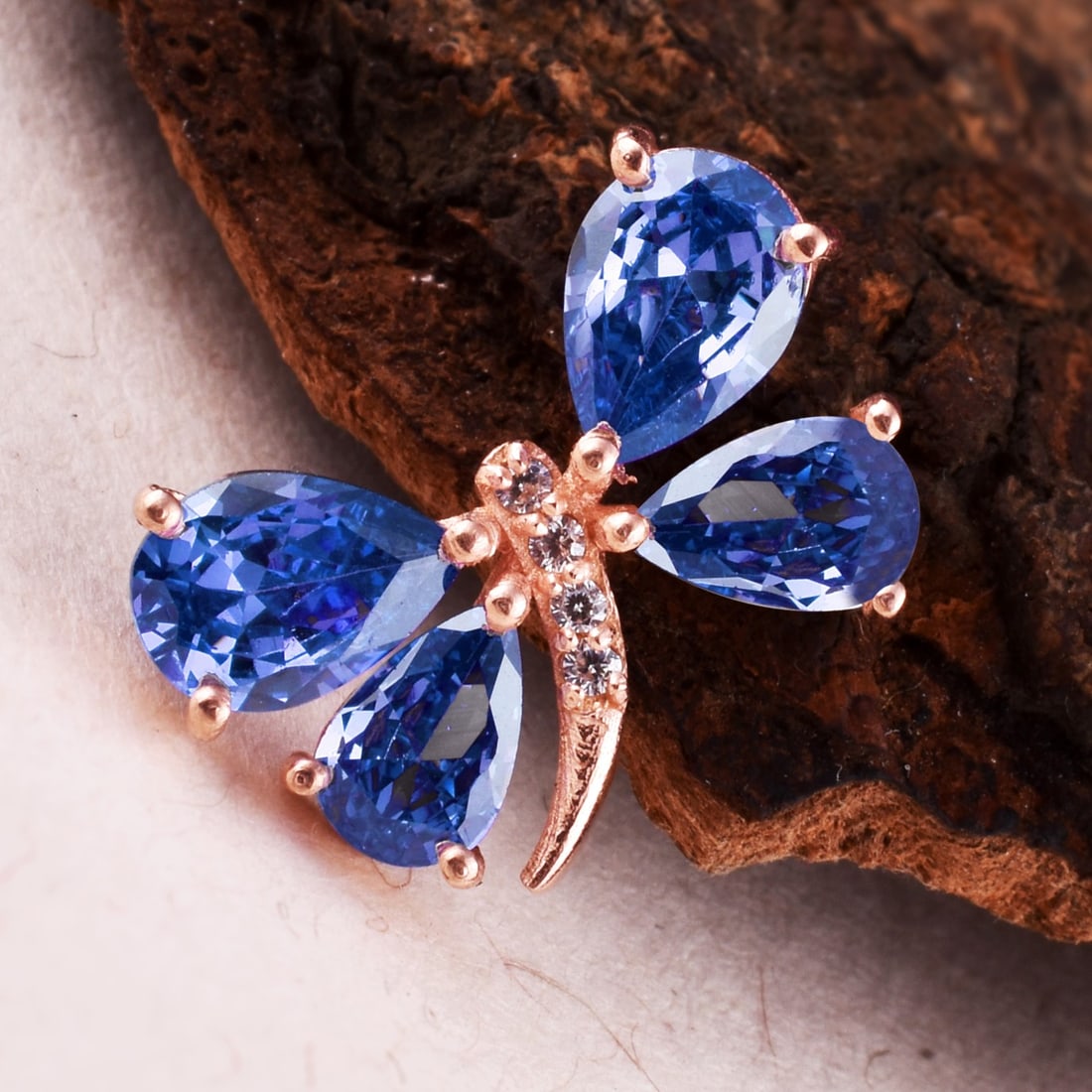 Natural Tanzanite & Diamond 14 KT Rose Gold Butterfly Pendant: Natural Tanzanite & Diamond 14 KT Rose Gold Butterfly Pendant Jewelry Type : Pendant Main Stone : Tanzanite & Diamond Main Stone Shape & Size : Pear 7x5 & 6x4 MM Main Stone Color : Blue Diamond Shape