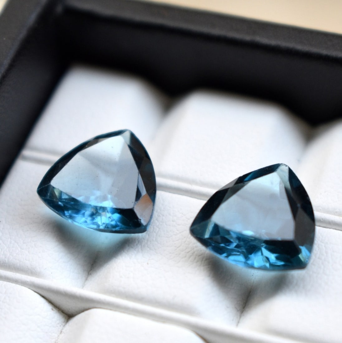 Natural London Blue Topaz 14 MM Trillion Cut Gemstone Pair: Natural London Blue Topaz 14 MM Trillion Cut Gemstone Pair Gemstone : London Blue Topaz Stone Shape : Trillion Stone Cutting Type : Faceted Cut Stone Weight : 21.00 Carats Stone Measurement :