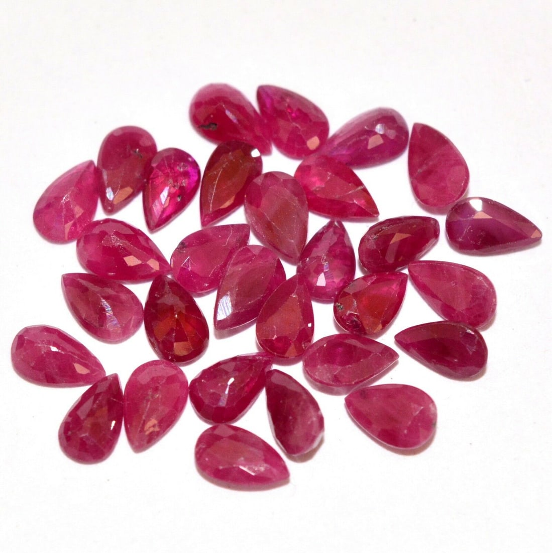 Ruby 6x4 MM Pear Faceted Cut 25 Pieces: Natural Ruby 6x4 MM Pear Faceted Cut 25 Pieces Gemstone : Ruby Shape : Pear Size : 6x4 MM Color : Red Type : Faceted Cut Quantity : 25 Pieces Weight : 13.5 Carats