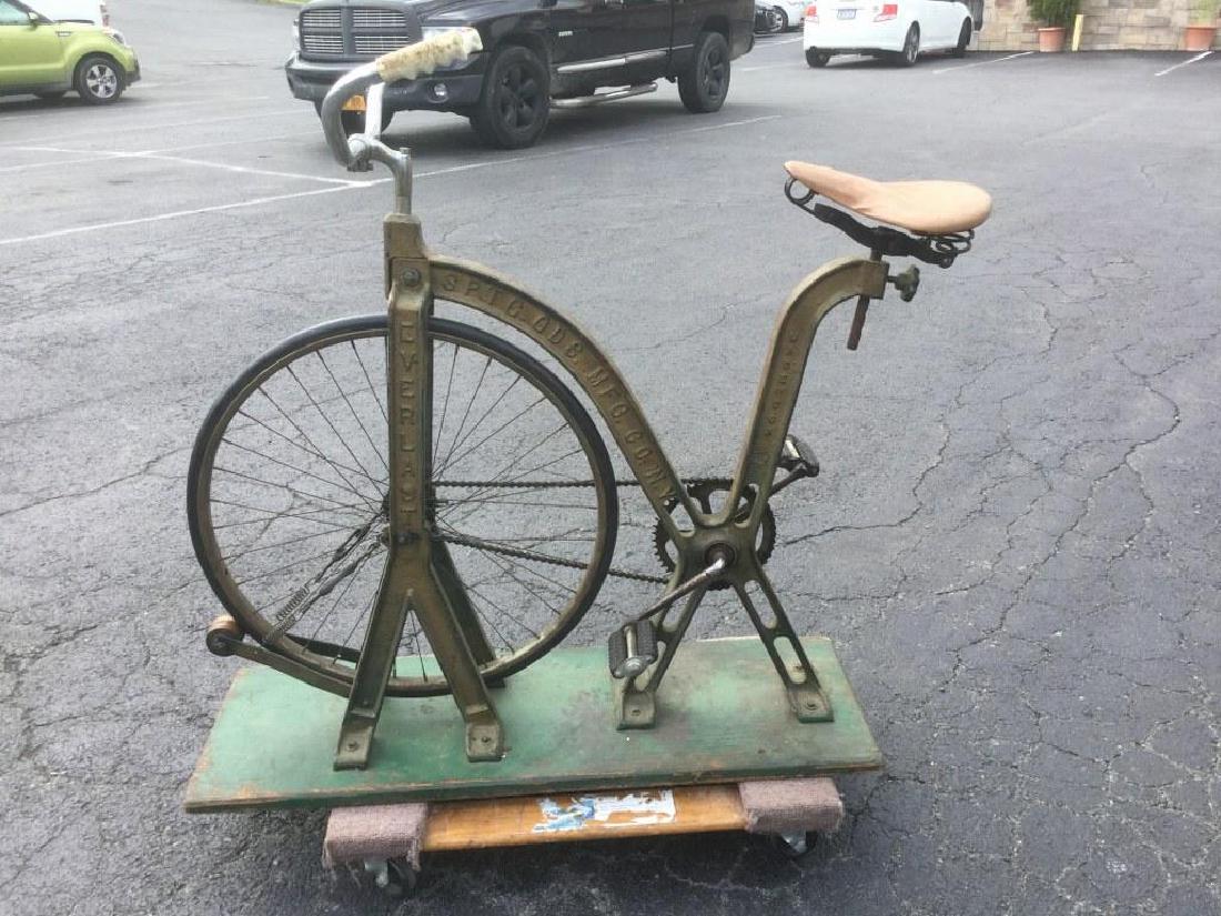 EARLY EVERLAST SPORTING GOODS N.Y. CAST IRON EXERCISE: EARLY EVERLAST SPORTING GOODS N.Y. CAST IRON EXERCISE BICYCLE, CIRCA 1900, GREAT DESIGN, ON GREEN BASE. APPEARS TO HAVE A LATER HANDLE BARS, THIS IS IT HOW IT WAS FOUND IN OLD LONG ISLAND ESTATE CARRI
