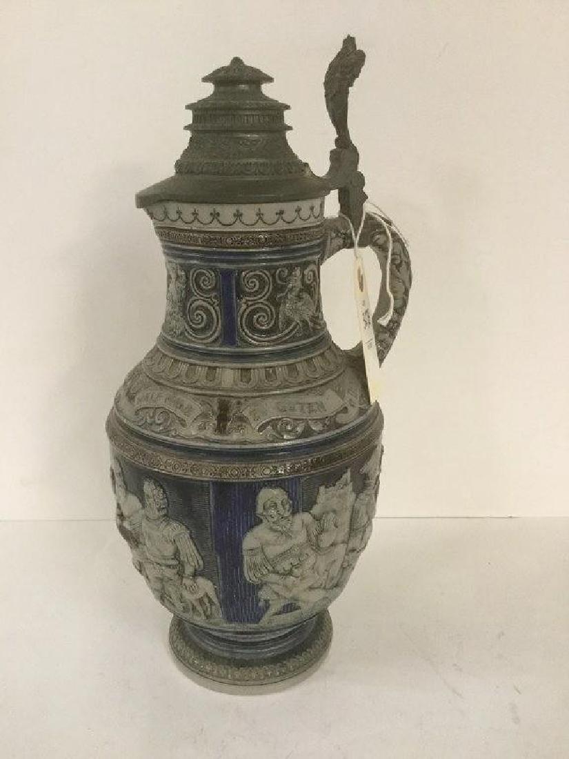 OLDER GERMAN STEIN W/FIGURES ALL THE WAY AROUND: OLDER GERMAN STEIN W/FIGURES ALL THE WAY AROUND DRINKING AND PLAYING MUSIC, NUMBER ON BOTTOM IS 138, PEWTER LID, MEASURES 14" HIGH, AS PICTURED