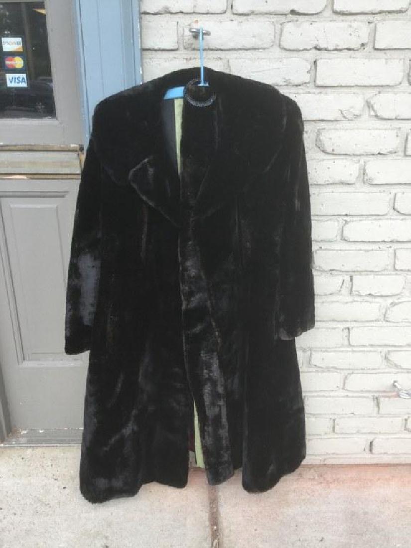 BLACK SEAL FUR COAT WITH BELT, FROM WOODSTOCK NY: BLACK SEAL FUR COAT WITH BELT, FROM WOODSTOCK NY ESTATE, MEASURES 41" FROM TOP OF SHOULDER TO BOTTOM OF COAT, MEASURES 24" FROM TOP OF SHOULDER TO END OF SLEEVE, & 17" FROM SHOULDER TO SHOULDER, AS PI