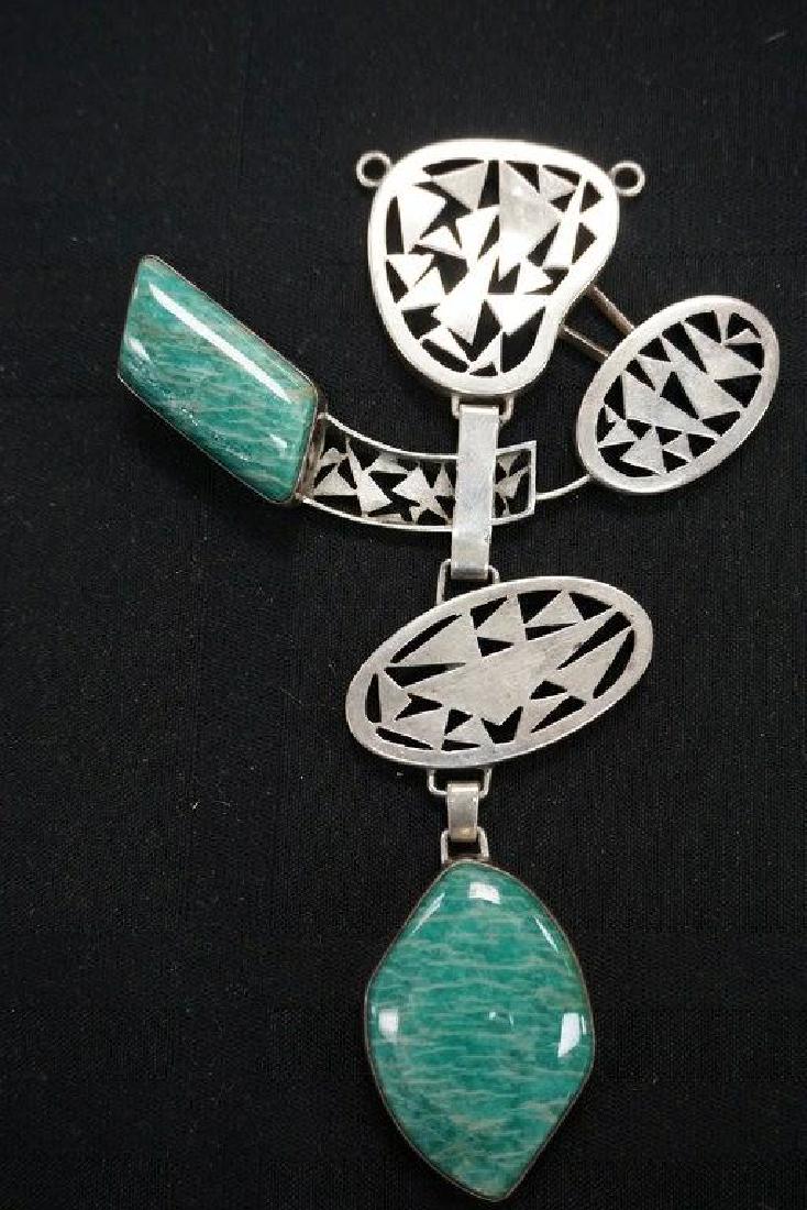 ROLPH SCARLETT AMAZONITE & STERLING PENDANT NECKLACE,: ROLPH SCARLETT AMAZONITE & STERLING PENDANT NECKLACE, DIRECTLY FROM HIS WOODSTOCK, NEW YORK ESTATE, PENDANT MEASURES 5 1/2" X 3 1/2"". HAS INTRICATE SCROLL CUTOUTS, CIRCA 1960'S. THE 15 LOTS OF ROLPH