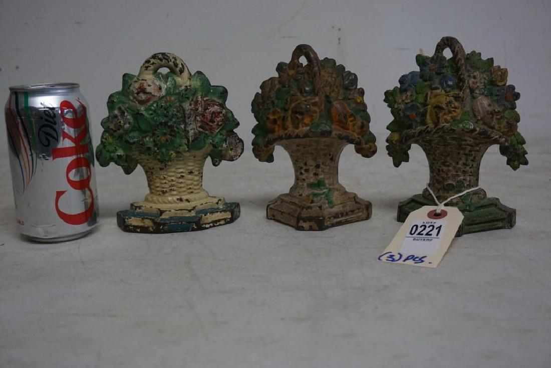 (3) OLD CAST IRON FLORAL BASKET DOORSTOPS, ORIGINAL: (3) OLD CAST IRON FLORAL BASKET DOORSTOPS, ORIGINAL PAINT, FROM HUDSON VALLEY ESTATE COLLECTION. THEY MEASURES 6 " HIGH.