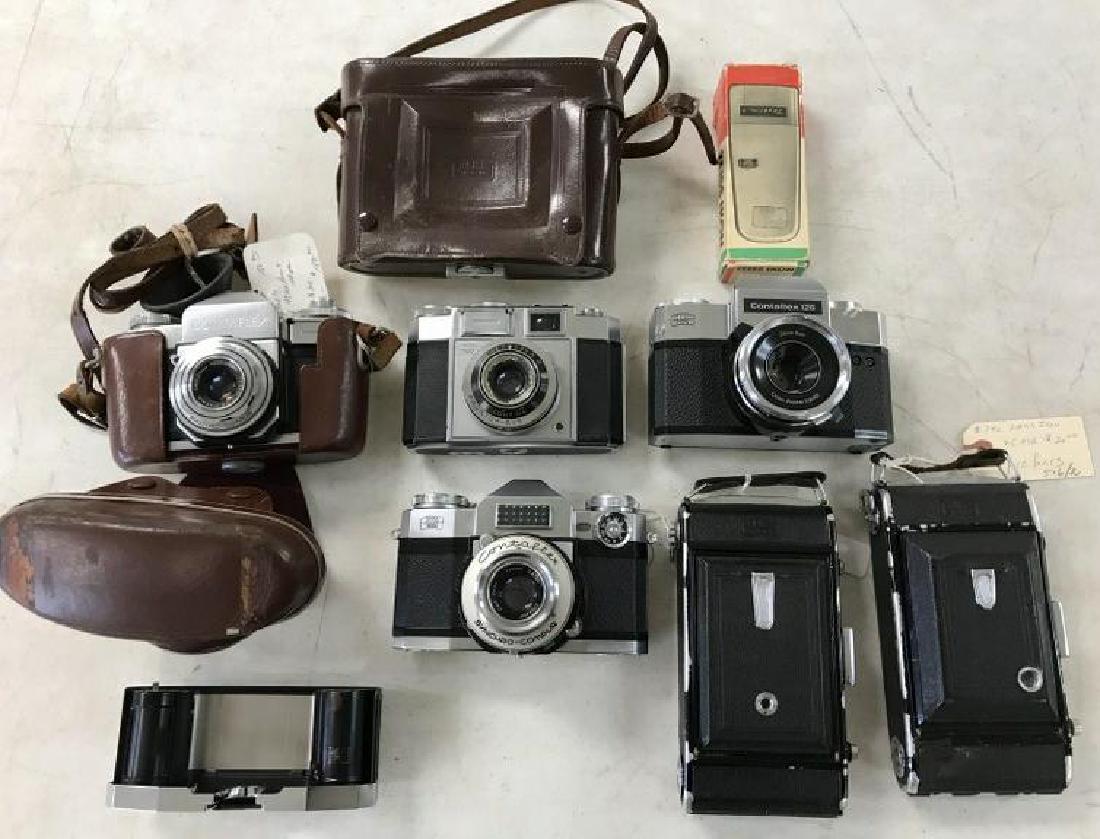 ZEISS IKON CAMERA LOT INCL. (4) 35 MM CAMERAS, 2: ZEISS IKON CAMERA LOT INCL. (4) 35 MM CAMERAS, 2 FOLDING CAMERAS, ( 1 HAS LABEL NOT WORKING, FOR PARTS ), LEATHER CASE, AND LIGHT METER IN BOX, AS PICTURED. INCLUDES CONTINAAND 3 CONTAFLEX CAMERASâ��
