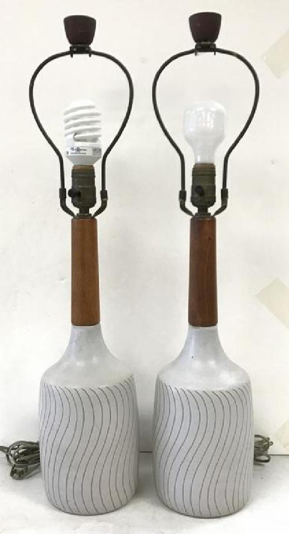GORDON MARTZ PAIR MID CENTURY ART POTTERY TABLE LAMPS,: GORDON MARTZ PAIR MID CENTURY ART POTTERY TABLE LAMPS, BOTH SIGNED ON BACKS, MEASURE 26 1/2" HIGH TO TOP OF PERIOD ORIGINAL FINIALS. ONE HAS SMALL CHIP WHERE WOOD MEETS BASE, JUST NOTICED, DOES NOT DE