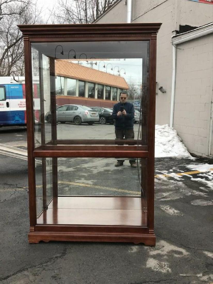 HOWARD MILLER BEAUTIFUL DISPLAY CABINET WITH LIGHTS,: HOWARD MILLER BEAUTIFUL DISPLAY CABINET WITH LIGHTS, PLATE GLASS SHEVES, BEVELED GLASS, AND DOORS THAT SILDE EITHER WAY FOR EASY ACCESS. IN WONDERFUL CONDITION, THE (3) THAT WE ARE SELLING COME FROM T