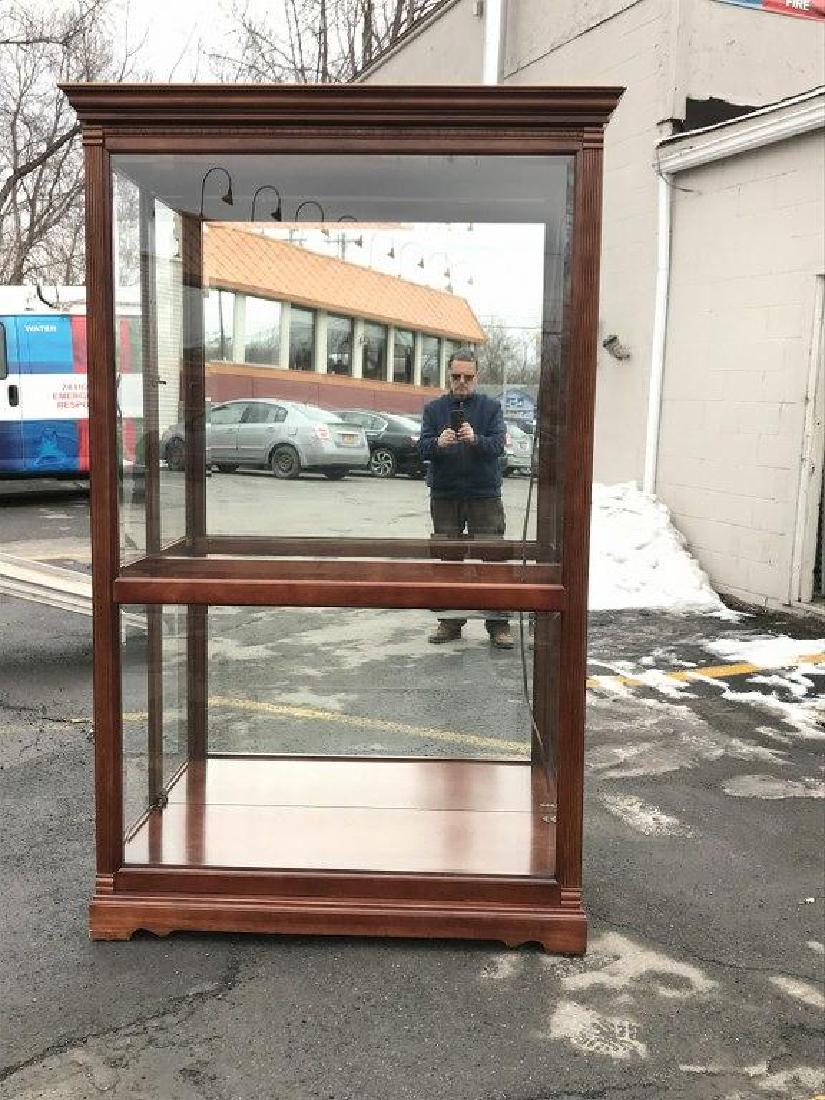 HOWARD MILLER BEAUTIFUL DISPLAY CABINET WITH LIGHTS,: HOWARD MILLER BEAUTIFUL DISPLAY CABINET WITH LIGHTS, PLATE GLASS SHEVES, BEVELED GLASS, AND DOORS THAT SILDE EITHER WAY FOR EASY ACCESS. IN WONDERFUL CONDITION, THE (3) THAT WE ARE SELLING COME FROM T