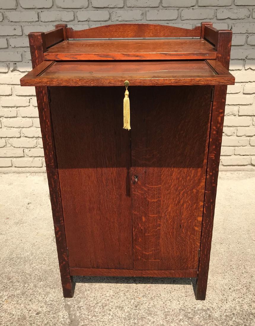 MISSION OAK BAR CABINET, NO MAKER: MISSION OAK BAR CABINET, NO MAKER'S LABEL, 2 DOORS WITH PULL OUT COPPER TRAY, METAL DOOR INSIDE W/1 DRAWER AND SHELVES, NICE FINISH, MEASURES 40" HIGH, 24" WIDE & 16" DEEP, AS PICTURED