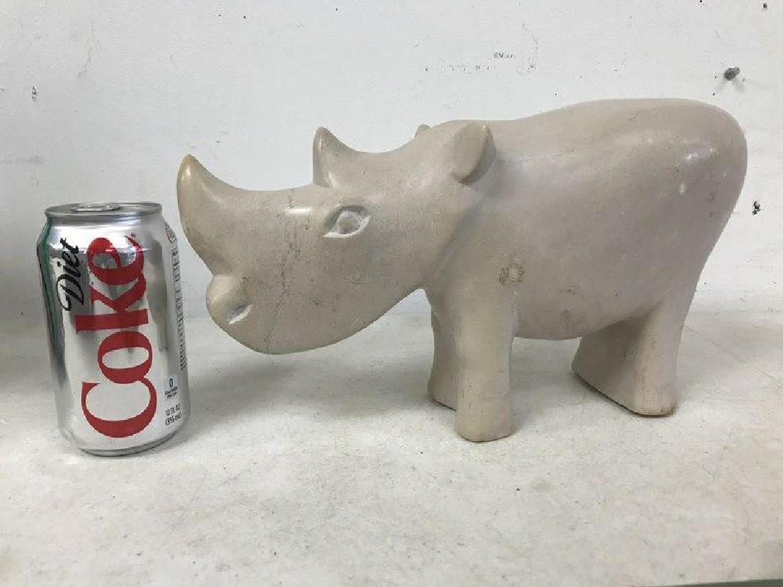 INUIT CARVED STONE RHINO, UNSIGNED, FROM ESTATE: INUIT CARVED STONE RHINO, UNSIGNED, FROM ESTATE COLLECTION OF BETTY BALLANTINE, BEARSVILLE, N.Y. MEASURES 12 3/4" FRONT TO BACK.