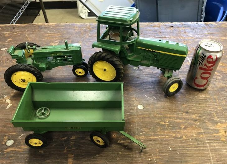 (3) JOHN DEERE VINTAGE DEALERSHIP TOYS, INCLUDES 2: (3) JOHN DEERE VINTAGE DEALERSHIP TOYS, INCLUDES 2 TRACTORS AND A WAGON, FROM SAME COLLECTION AS OTHERS WE ARE SELLING.