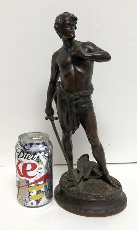 PAUL LUDWIG KOWALCZEWSKI BRONZE MAN WITH SWORD, WITH: PAUL LUDWIG KOWALCZEWSKI BRONZE MAN WITH SWORD, WITH HELMET ON GROUND, SIGNED ON BASE AS PICTURED, MARKED GERMANY ON THE SIDE OF THE BASE, NICE PATINA, FROM ALBANY, N.Y. ESTATE, MEASURES 13 1/8" HIGH.