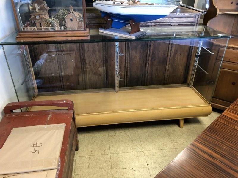 1940: 1940'S FLOOR SHOWCASE, WITH 2 WOOD SLIDING DOORS ON BACK, THICK PLATE GLASS TOP, MEASURES 70" X 17.5" DEEP X 38" HIGH, HAS ONE GLASS SHELF.