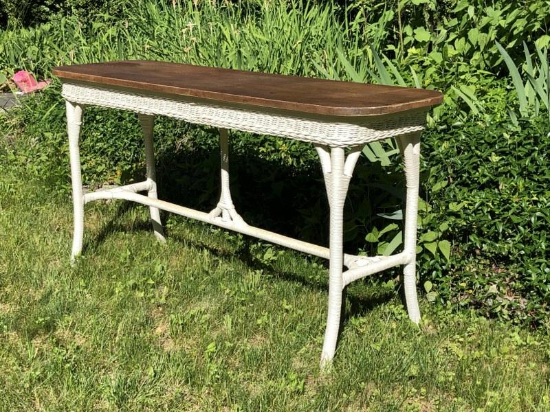 1920'S LONG WICKER TABLE WITH OAK TOP, NICE SOLID: 1920'S LONG WICKER TABLE WITH OAK TOP, NICE SOLID STRUCTURALLY, SOME LIGHT STAINS ON OAK TOP, GREAT LOOKING, AND HARD TO FIND THIS CONSOLE SIZE. MEASURES 60" LONG X 18" WIDE X 31" HIGH. HAS QUARTER SE