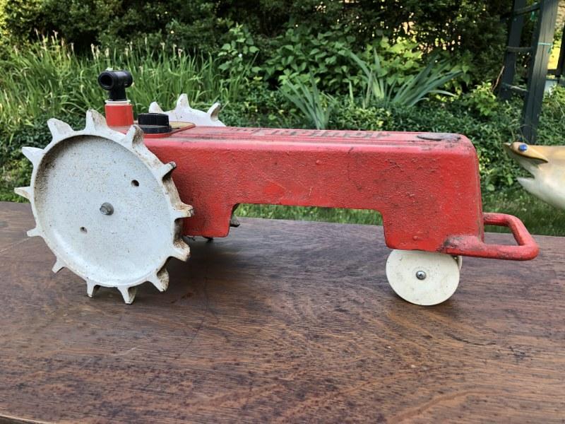 OLDER MELNOR CAST IRON TRACTOR SHAPED SPRINKLER.: OLDER MELNOR CAST IRON TRACTOR SHAPED SPRINKLER. MEASURES 19" LONG, GOOD ESTATE FOUND CONDITION.