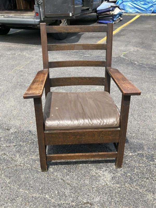 MISSION OAK ARMCHAIR, ORIGINAL FINISH, UNSURE OF MAKER: MISSION OAK ARMCHAIR, ORIGINAL FINISH, UNSURE OF MAKER (STICKLEY BROS. ?), FROM NYC WEEKENDERS HOME. LEATHER CUSHION HAS TEAR ON ONE SIDE.