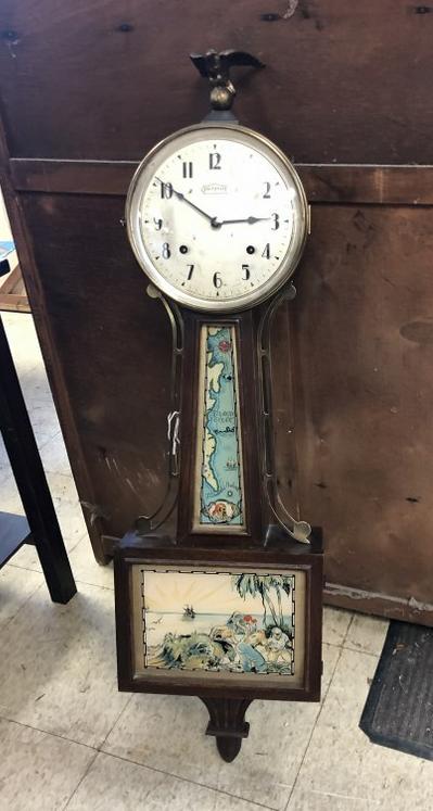 INGRAHAM WALL CLOCK WITH PIRATES & MAP ON GLASS PANELS,: INGRAHAM WALL CLOCK WITH PIRATES & MAP ON GLASS PANELS, FROM LOCAL ESTATE, HAS PENDULUM, HAS KEY, EAGLE FINIAL, MAHOGANY BODY IS NICE CONDITION, SOME WEAR TO FINISH HERE AND THERE, MEASURES 38" TOP TO
