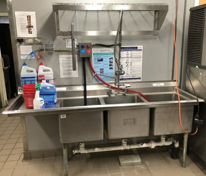 STAINLESS STEEL 3 BAY SINK WITH DETERGENT DISPENSER: STAINLESS STEEL 3 BAY SINK WITH DETERGENT DISPENSER CLEANING SYSTEM. MEARUES 80" WIDE, 24" DEEP, 39" HIGH TO BACKSPLASH ALSO INCLUDES HANGING RACK ABOVE SINK. THIS LOCATION IS LOCATED AT 295 WALL STRE
