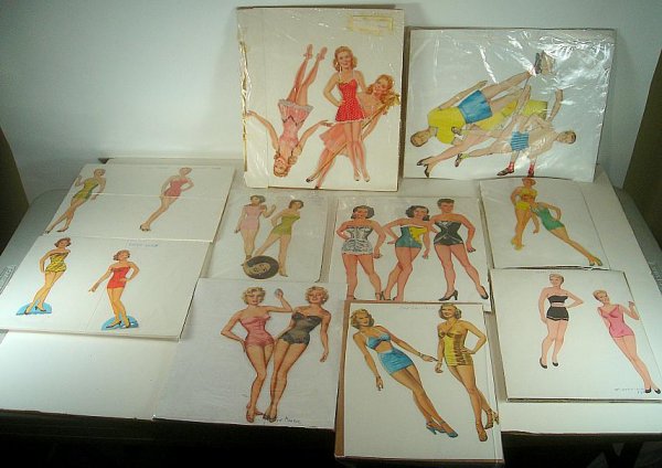 LARGE LOT VINTAGE PAPER DOLLS, INCLUDING JANE POWELL, A: LARGE LOT VINTAGE PAPER DOLLS, INCLUDING JANE POWELL, ALICE FAYE, PATTI PAGE, JOAN CAULFIELD, MARILYN MONROE, JANE RUSSELL, ELIZABETH TAYLOR, THE NELSON'S, DONNA REED, AND DINAH SHORE, HAS PAPER DOLLS