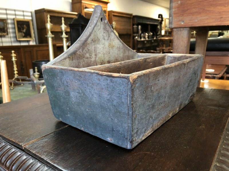 EARLY WALL HANGING PRIMITIVE BOX, IN OLDER BLUISH: EARLY WALL HANGING PRIMITIVE BOX, IN OLDER BLUISH PAINT, BEAUTIFUL WEAR TO PAINT, GREAT FORM, WAS HANGING IN MARLBORO, N.Y . FARMHOUSE. MEASURES 12.25" ACROSS X 8" DEEP X 9" HIGH TO TOP OF BACK.