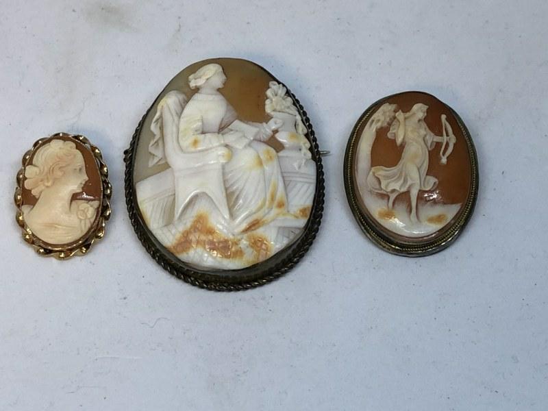(3) OLD ESTATE CAMEO BROOCHES, THE WOMAN PORTRAIT IS: (3) OLD ESTATE CAMEO BROOCHES, THE WOMAN PORTRAIT IS MARKED 10K, THE WOMAN WITH BOW IS MARKED 900, AND THE LARGER ONE I BELIEVE IS SILVER PLATE, ALL IN NICE AS FOUND CONDITION, I SEE NO DAMAGES.