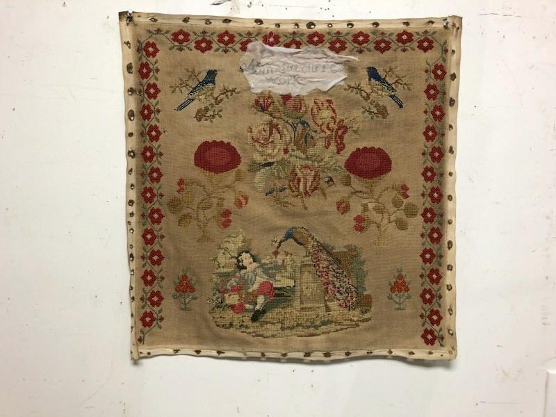 ANN SUTCLIFFE NEEDLEPOINT TAPESTRY, FROM COLUMBIA: ANN SUTCLIFFE NEEDLEPOINT TAPESTRY, FROM COLUMBIA COUNTY, N.Y. ESTATE, MEASURES 26" X 25". SOMEONE HANDSTICTCHED LOOSELY A PIECE OF MATERIAL OVER HER NAME, AS THE MATERIAL WAS SEPARATING.