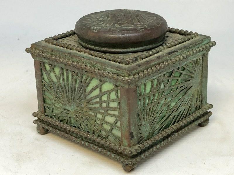 TIFFANY STUDIOS PINE NEEDLE INKWELL, WITH WONDERFUL: TIFFANY STUDIOS PINE NEEDLE INKWELL, WITH WONDERFUL PATINA, IN NICE CONDITION, MISSING GLASS INSERT. MEASURES 3" HIGH X 3.25" X 3.25". ALL GLASS INTACT, SIGNED ON BOTTOM.