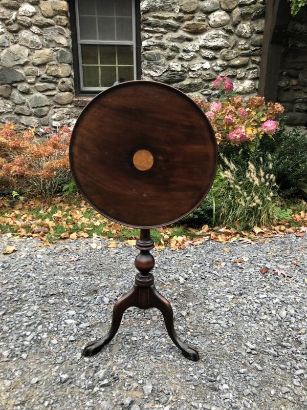 EARLY DIMUNITIVE WALNUT TILT TOP STAND, WITH SMALL: EARLY DIMUNITIVE WALNUT TILT TOP STAND, WITH SMALL INLAID CIRCLE IN CENTER, STRUCTURALLY SOUND, FROM COLUMBIA COUNTY, N.Y. ESTATE, TOP MEASURES 18" ACROSS. NOT OPEN IT STANDS 34.75" HIGH.