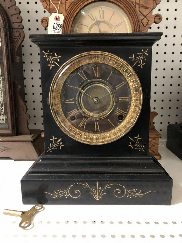 BLACK IRON MANTEL CLOCK, WITH GOLD DETAIL, FROM: BLACK IRON MANTEL CLOCK, WITH GOLD DETAIL, FROM WORKSHOP OF OLD TIME CLOCK REPAIRMAN, RUNNING, HAS PENDULUM & KEY, CLEAN CONDITION, PROBABLY ANSONIA, MEASURES 10.75" HIGH X 9.5" WIDE.
