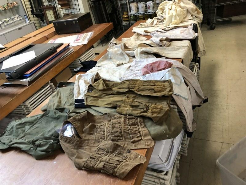 OLD FARMHOUSE CLOTHES FIND, IN OLD TRUNK, NAVY WHITES,: OLD FARMHOUSE CLOTHES FIND, IN OLD TRUNK, NAVY WHITES, DUFFEL BAGS, HUNTING VESTS, SOME LADIES WHITES, AS FOUND ESTATE CONDITION.