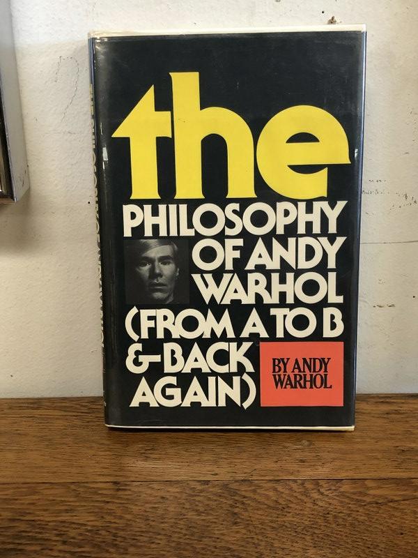 SIGNED ANDY WARHOL BOOK, THE PHILOSOPHY OF ANDY WARHOL: SIGNED ANDY WARHOL BOOK, THE PHILOSOPHY OF ANDY WARHOL (FROM A TO B & BACK AGAIN ) FIRST EDITION, 1975, INITIALED WITH BLACK MARKER ON TITLE PAGE. WITH DUST JACKET, AND PROTECTIVE COVER OVER DUST JACK
